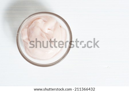 cosmetic cream on bright wooden background