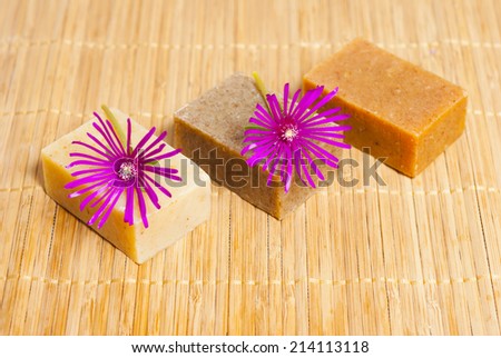 little soap blocks with purple flowers on bamboo