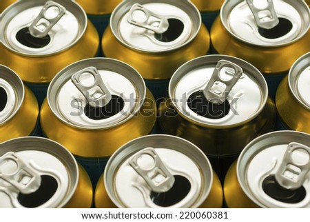 many same and one different opened beer can