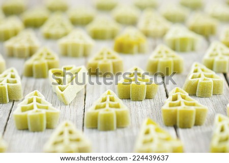 uncooked christmas tree shape pasta on wooden table