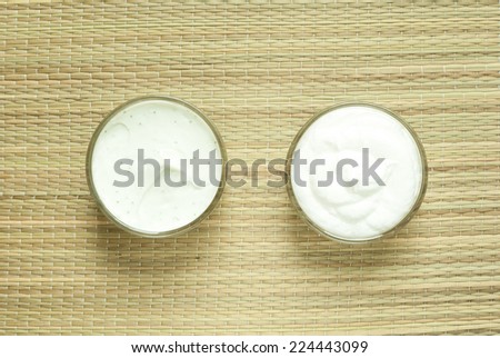 cosmetics cream and oil on bamboo background, directly above