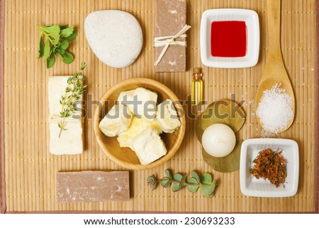 natural moisturizer, bath salt, soaps, dried st johns wort and red oil from hypericum perforatum on bamboo background