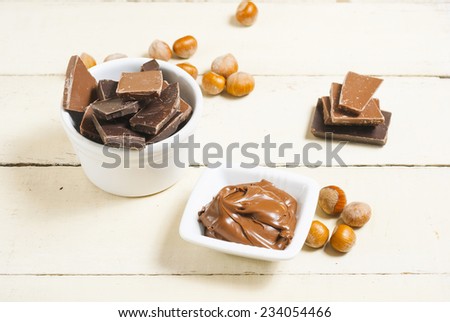 hazelnut cream and broken chocolate on bright wood table