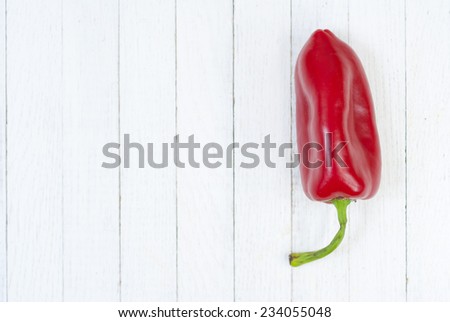 red pepper fruits on white wood table