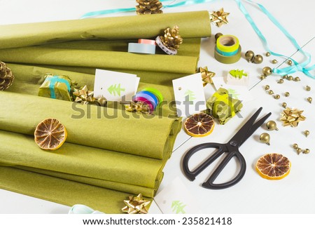 christmas gift packaging with green papers and cards with christmas tree print