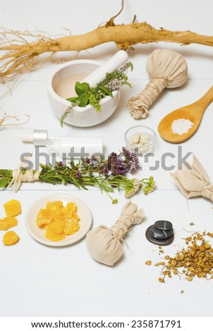 herbal plants, alternative therapy setting on white wooden table
