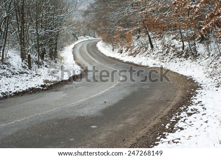 dangerous road in the woods at winter
