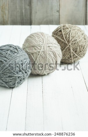 balls of wool on wooden background