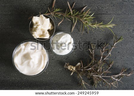 moisturizer and shea butter on dark wooden table