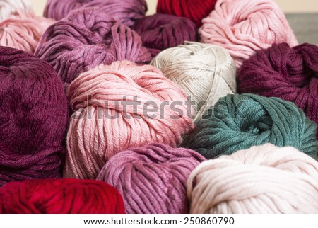 balls of wool on bamboo dish, rusty wood table background