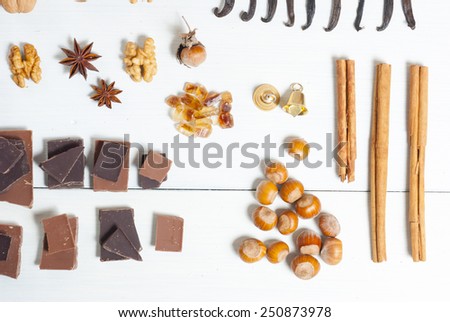 dessert spices in a row on white wooden table background