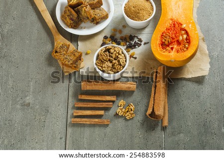 pumpkin cake and ingredients, aged wood table background