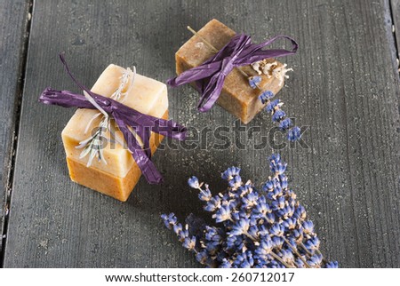 lavender soap and flower on rusty black wood