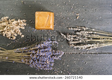 organic soap with blue and white lavender bouquets on dark wooden table