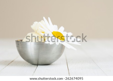 shea butter and chamomile on white wooden