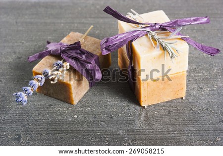 lavender soap and flower on rusty black wood