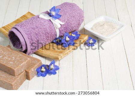 facial cleanser and handmade organic soap wood background