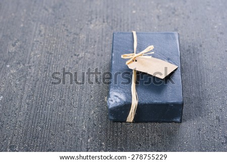 carbon soap with empty gift card on dark wooden table