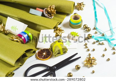 christmas gift packaging with green papers and cards with christmas tree print