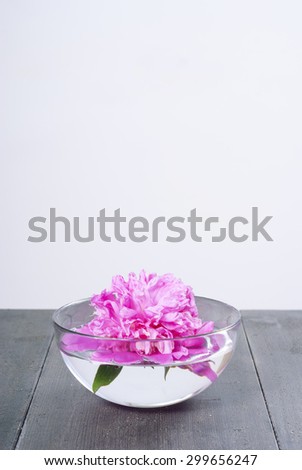 floating flower at aroma bowl on black wooden table