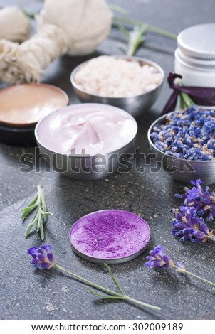 beauty product samples with  lavenders on dark wood table background