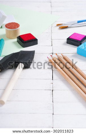 pencils,  plasticine blocks and ink pads on white wood