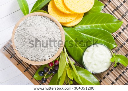 cosmetic clay in bamboo bowl and face cream