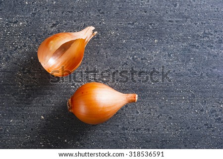 red onion and outer skin on black wood table background