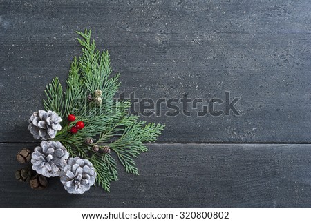 pine and cypress cones Christmas decoration on black wooden table background