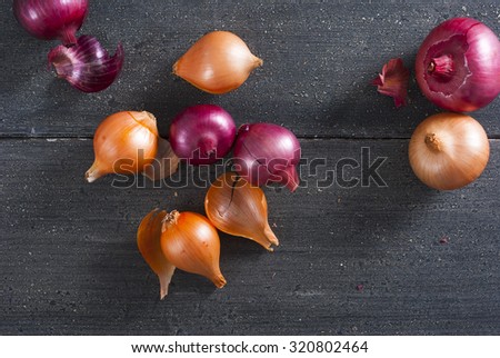 spanish and red onions on black wooden table