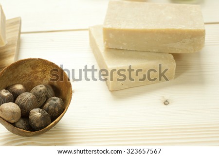 soaps and shea butter nuts on wooden