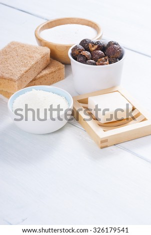soap nuts and other cleaner accessories on white wooden surface