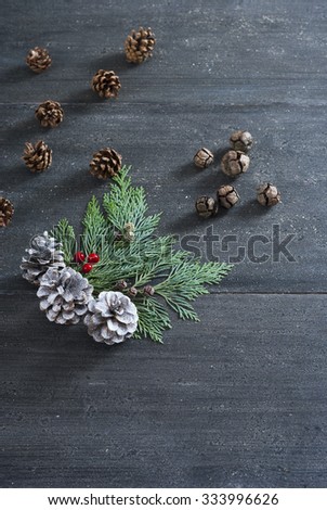 pine and cypress cones Christmas decoration on black wooden table background