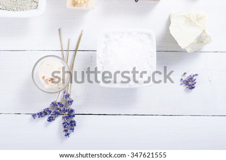spa products: cosmetic cream,  bath salt, shea butter and lavenders on white wood table background