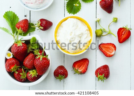 strawberry fruits and whipped cream dessert on white wood table background