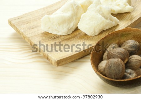 shea butter with shea butter nuts on wooden