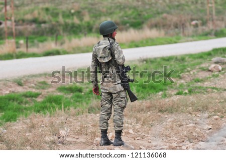 SANLIURFA, TURKEY - NOVEMBER 18:	Unidentified Turkish soldier guard along the border, due to the war in Syria on November 18, 2012 in Sanliurfa, Turkey.