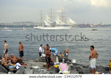 ISTANBUL, TURKEY - MAY 30: Istanbullians joyfully watched the sailing boats passing the Bosphorus Strait on May 30, 2010 in Istanbul, Turkey.