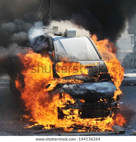 Burning van with large flames and black smoke