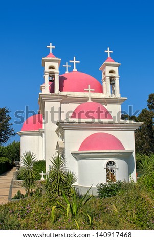 Vertical image of Greek Orthodox Church of the Seven Apostles under clear blue sky in Capernaum, Israel.