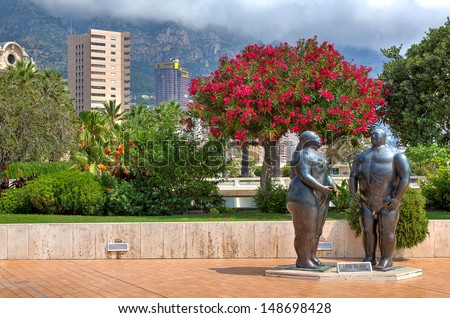 MONTE CARLO, MONACO - JULY 13: Adam and Eve composition - sculpted by Fernando Botero in 1981, situated in park near Casino and is one of the famous sculptures in Monte Carlo, Monaco in July 13, 2013.