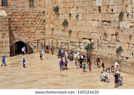 JERUSALEM - AUGUST 21: Prayers at Western Wall (aka Wailing Wall) - most important religious site in Judaism and one of popular places to visit for tourists in Jerusalem, Israel on August 21, 2013.
