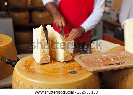 BRA - SEPTEMBER 22: Cut pieces of Parmesan - famous italian hard cheese made from raw cow\'s milk, often grated over dishes and named after producing areas near Parma, Italy on September 22, 2013.