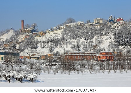 View of small italian town covered with snow in Piedmont, Northern Italy.