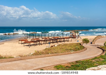 Walkway promenade along empty beach on Mediterranean sea in Ashkelon, Israel.