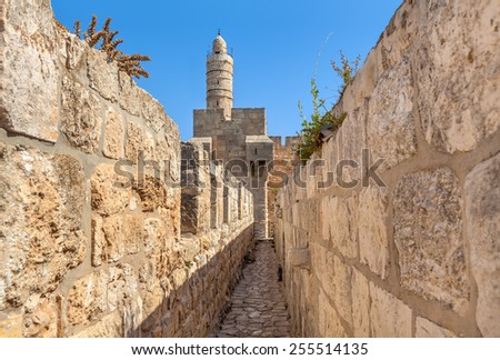 Tower of David and ancient walls under blue sky in Old City of Jerusalem, Israel.