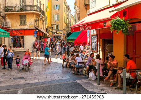 NICE, FRANCE - AUGUST 23, 2014: People in Old City of Nice - fifth most populous, second-largest French city on Mediterranean coast and one of the most visited with 4 million tourists every year.