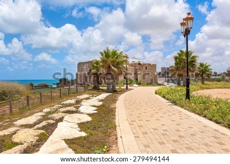 Pedestrian walkway, lampposts and ancient on promenade along Mediterranean sea coastline in Ashqelon, Israel.