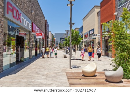 ASHDOD, ISRAEL - JULY 22, 2015: People among shops and boutiques in opened mall - owned by BIG Shopping Centers Ltd., founded in 1994 and operates in four countries - Israel, USA, India and Serbia.