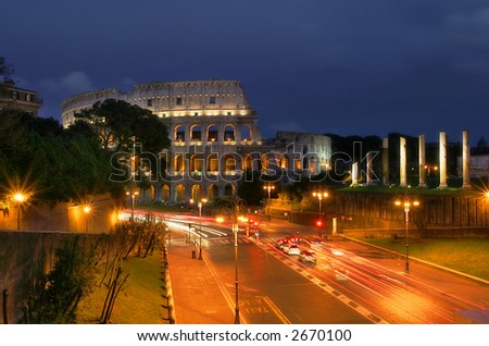 Famous roman Coliseum and illuminated streets of Rome at night.